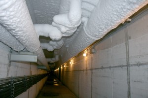 Die Rohre einer Eisbahn-Anlage sind mit einer weißen Eisschicht überzogen. Denn das Ammoniak in den Rohren verbreitet so viel Kälte. (Foto: dpa)